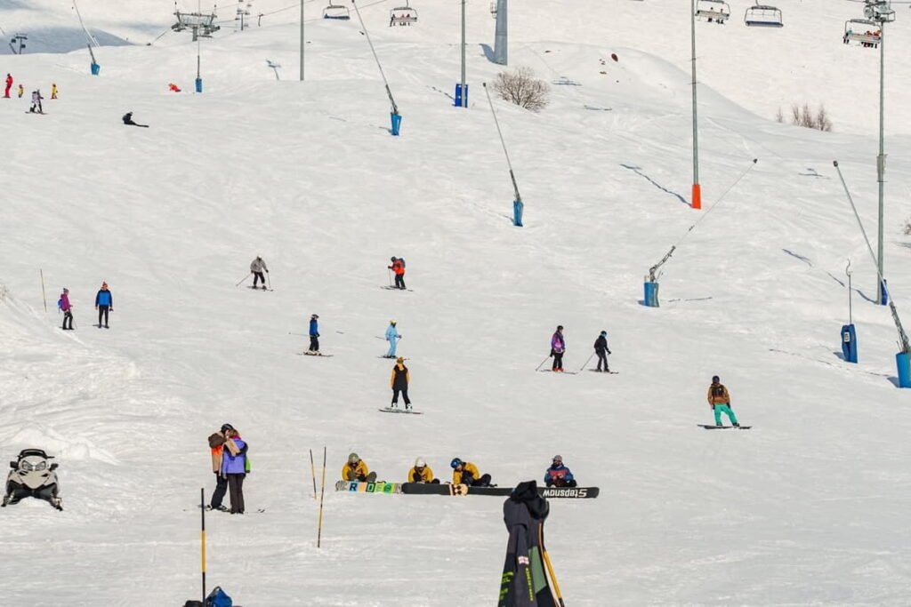 Ski slopes and skiers at Gudauri Ski Resort in the Caucasus Mountains Georgia